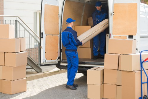 Van crew sorting furniture for reuse in a London street