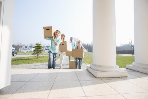Removal company staff transporting furniture