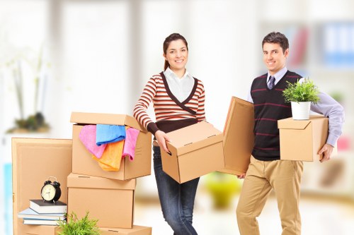 Removal company staff packing boxes efficiently