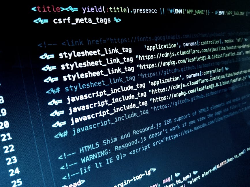 A person with short brown hair, dressed in a white shirt, working at a desk with multiple monitors. The main monitor displays a web development code editor with HTML code visible. An additional smalle